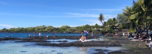 a group of people on a beach near a body of water